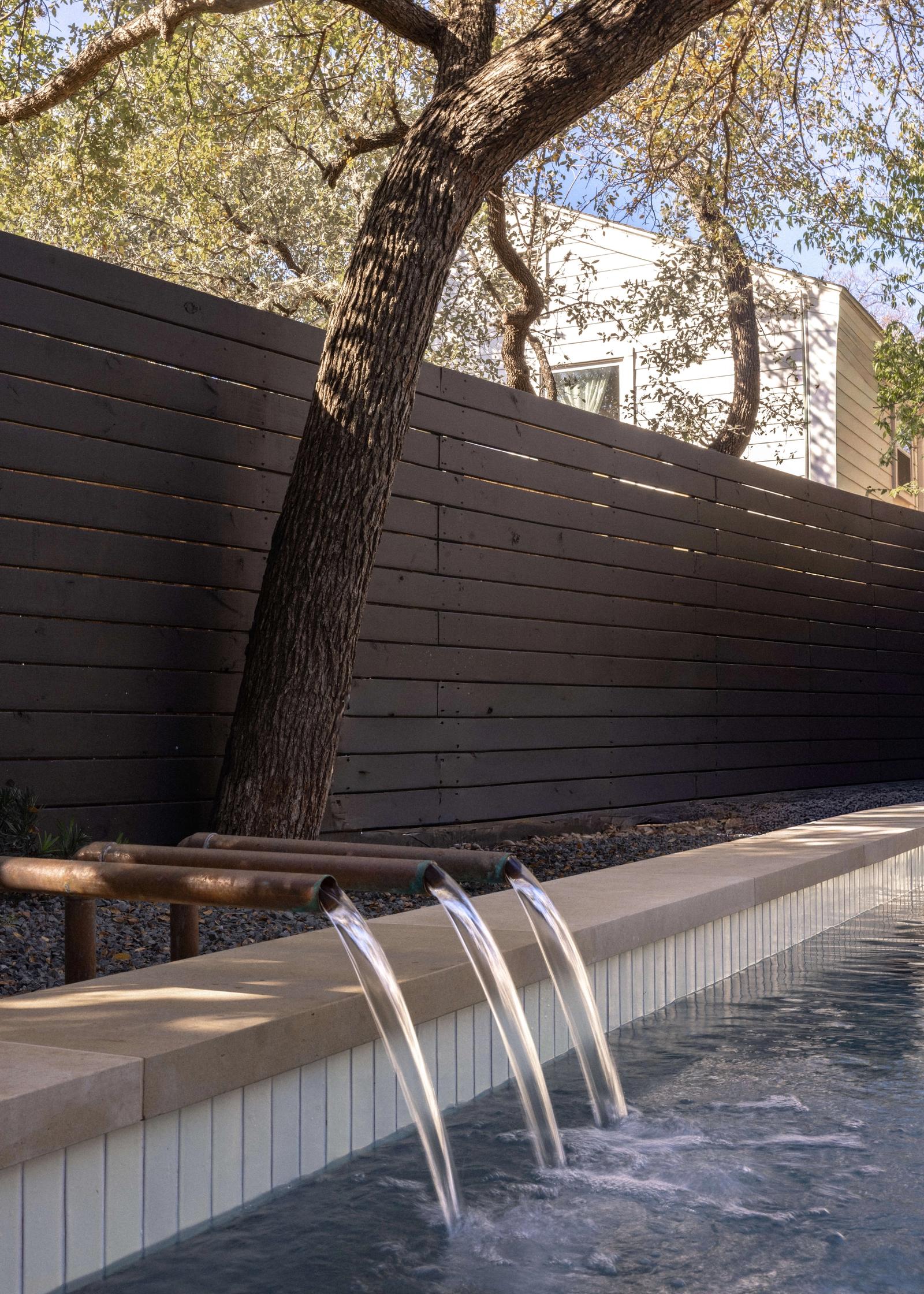 Golden Hour Pools Classic in Austin, featuring dark aesthetic with modern lines and gunite plaster finish