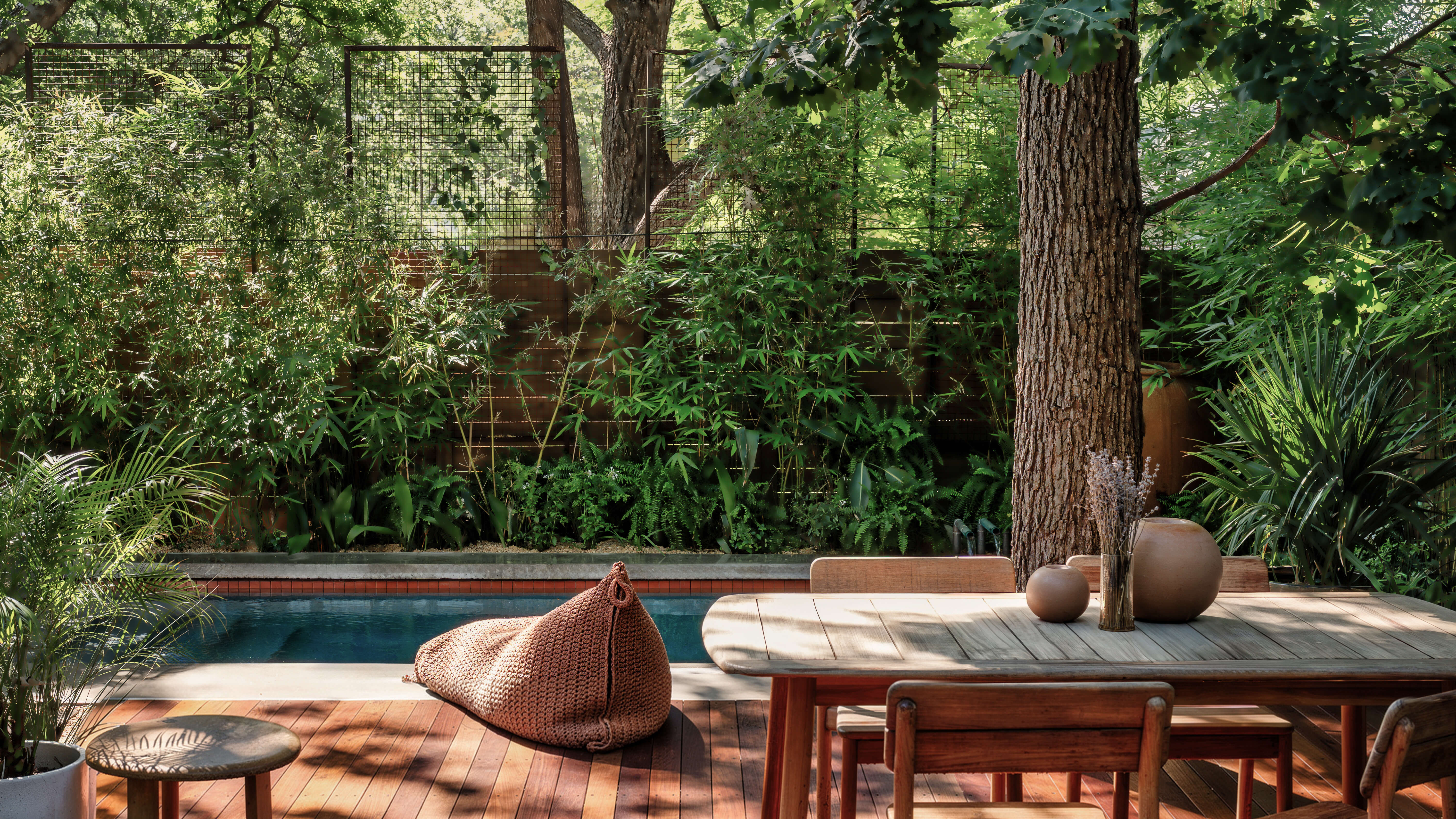Golden Hour Pools Classic in Austin, featuring Classic gunite pool with bamboo surround and teak deck dining area in Zilker