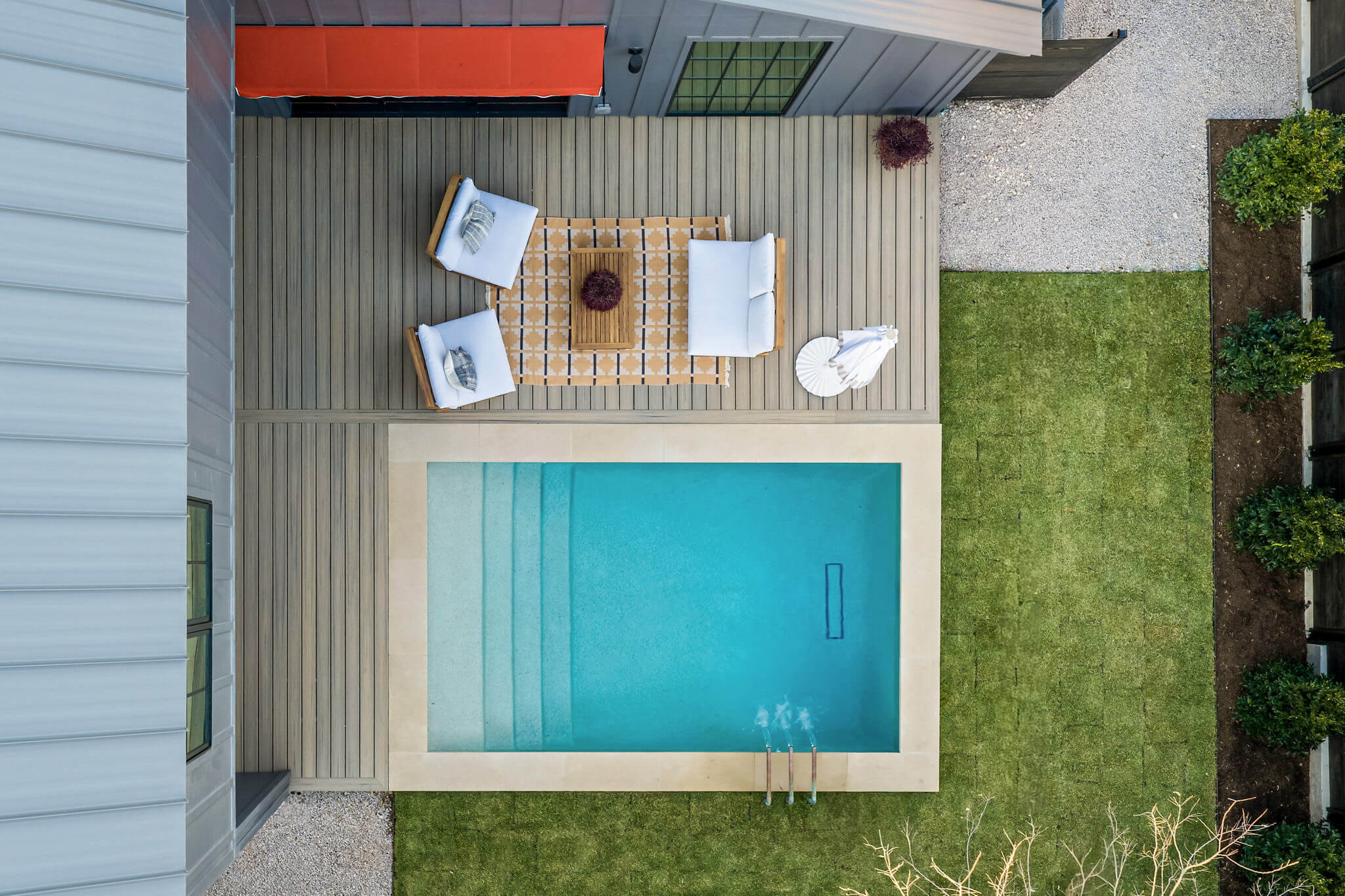 Golden Hour Pools Classic in Austin, featuring overhead view of pool with tanning ledge and manicured lawn and gunite plaster finish
