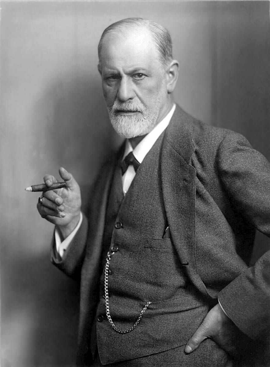 portrait of sigmund freud holding a cigar with his right hand