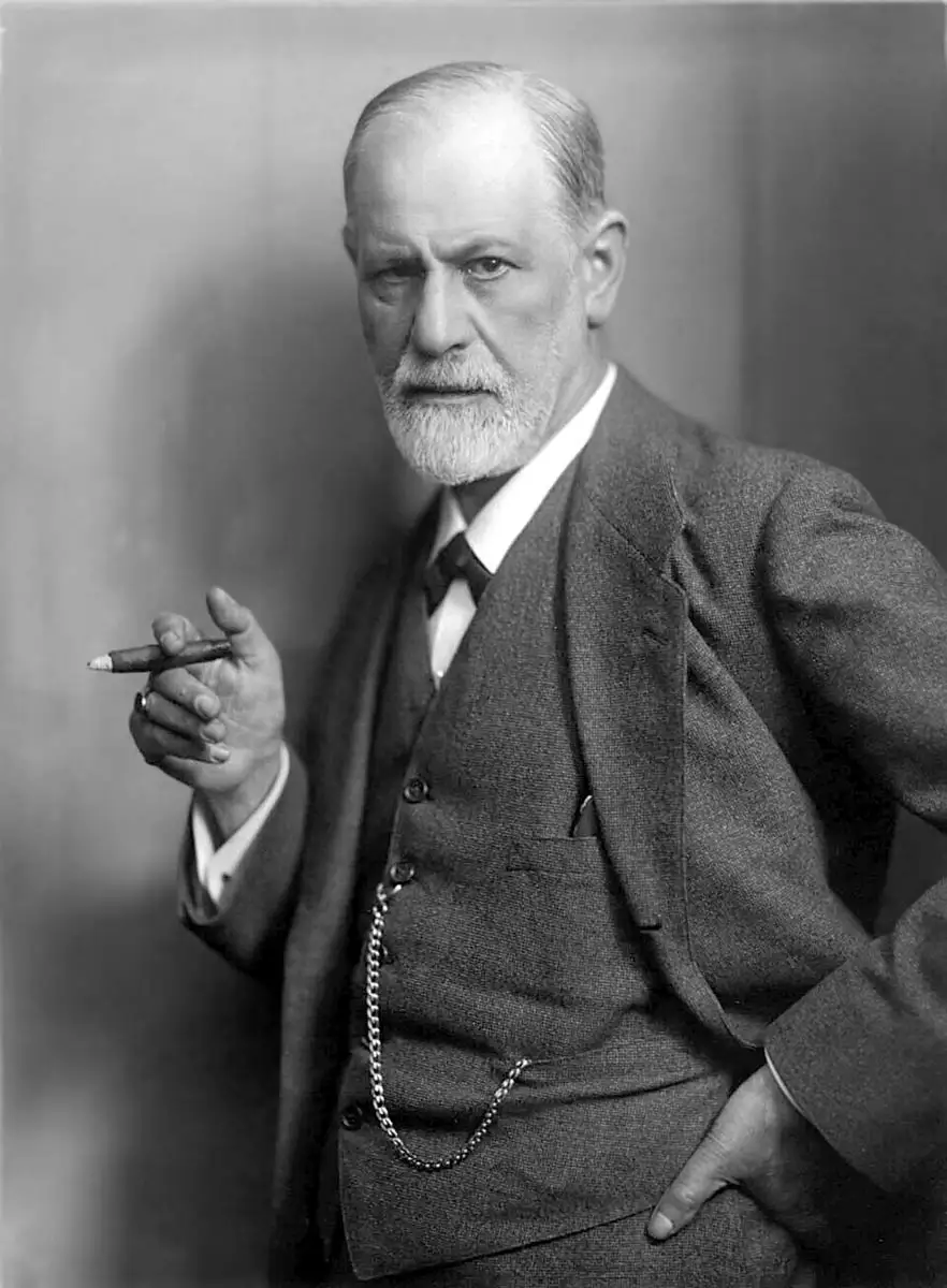 portrait of sigmund freud holding a cigar with his right hand