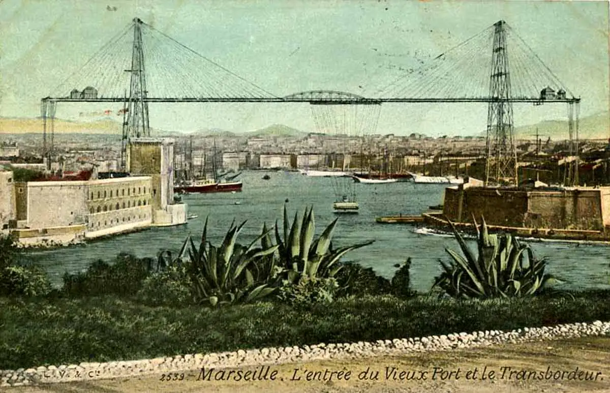 Vintage postcard of Marseille France showing the historic Transporter Bridge (Pont Transbordeur) at the entrance of the Vieux Port with sailing ships and agave plants.