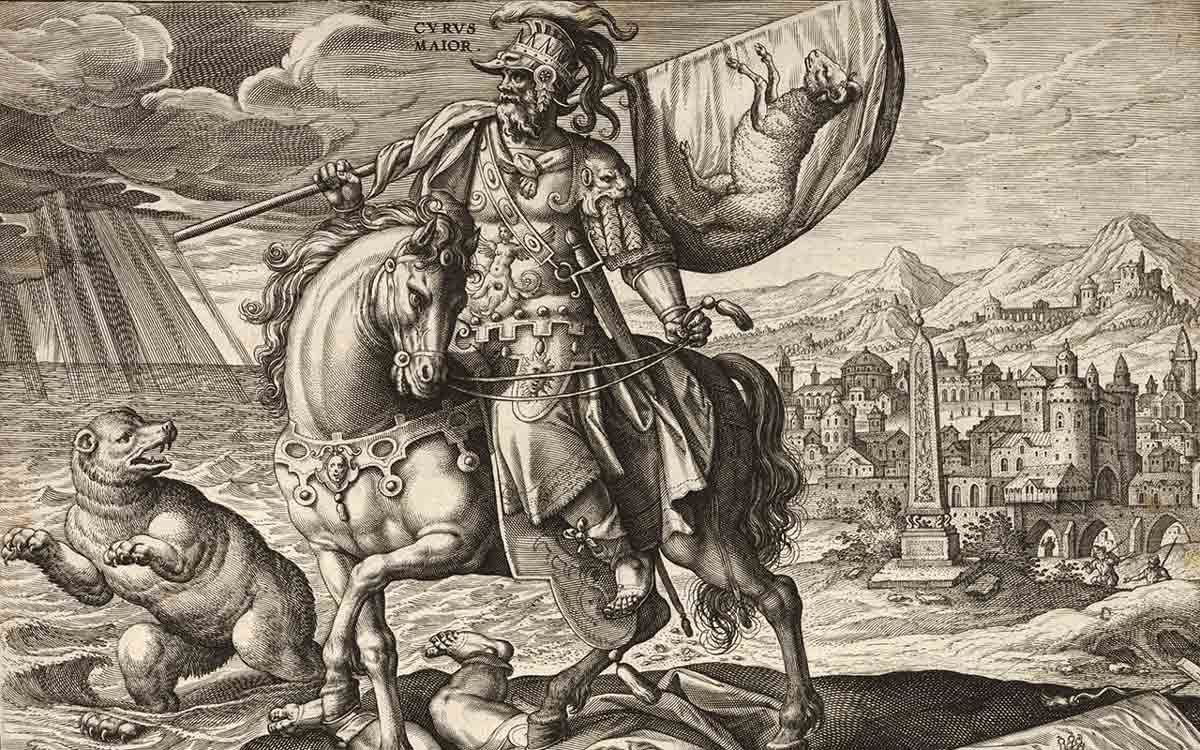 A detailed 16th-century style engraving titled "Cyrus Maior." It depicts Cyrus the Great in ornate armor on a horse, trampling a fallen enemy. A bear stands in the background to the left, and a sprawling ancient city with an obelisk is visible to the right.