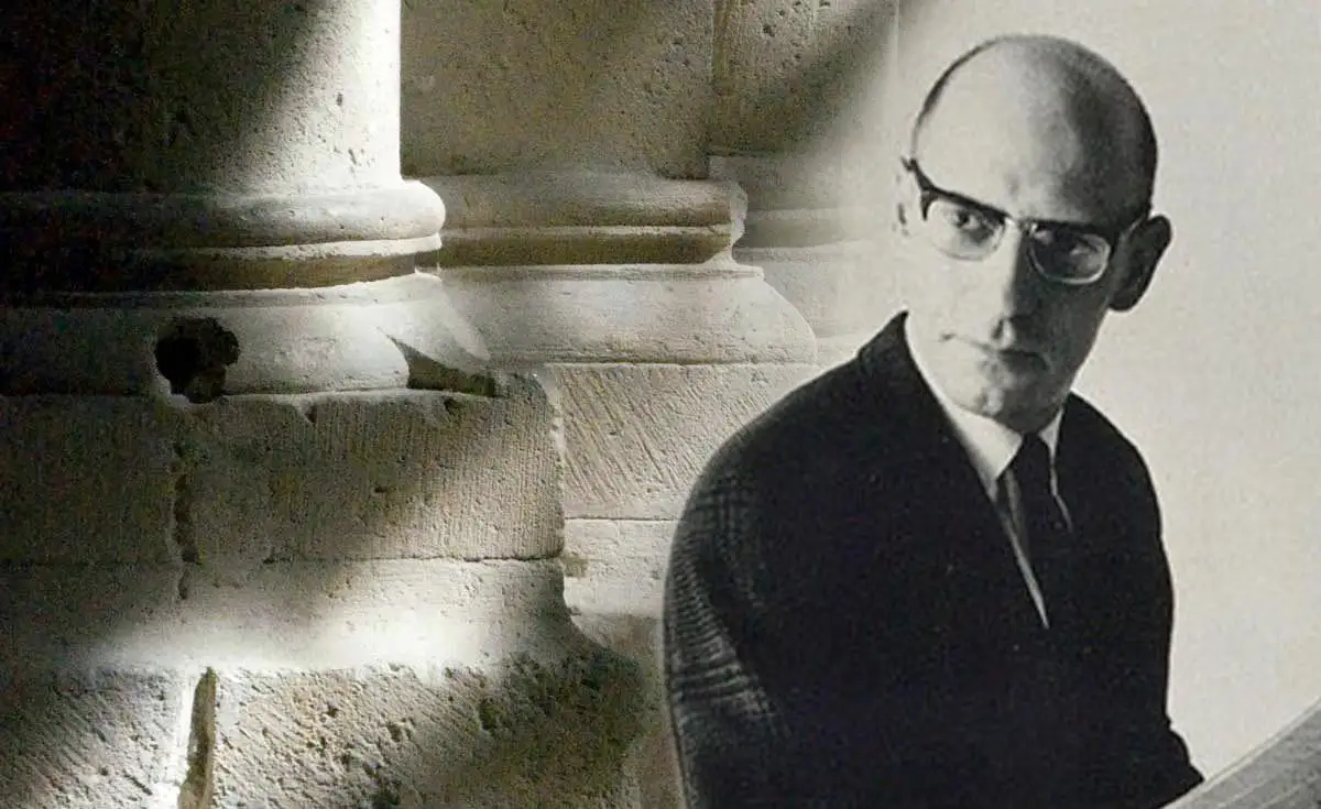Black and white portrait of the French philosopher Michel Foucault. He is shown laughing and wearing his signature thick-rimmed glasses and a white turtleneck. Foucault is the foundational theorist of biopolitics and disciplinary power.