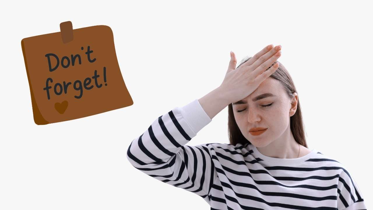 A woman holding her hand to her forehead with an stressed expression, alongside a brown sticky note taped to the side that reads "Don't forget!".