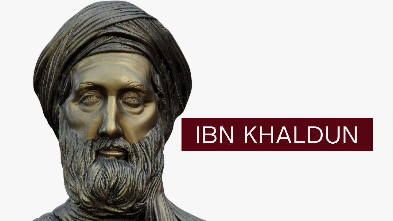 A bronze-colored bust of a bearded man wearing a turban, set against a white background. Overlaid to the right of the figure is a dark red rectangular label containing the text "IBN KHALDOUN" in white, sans-serif letters.