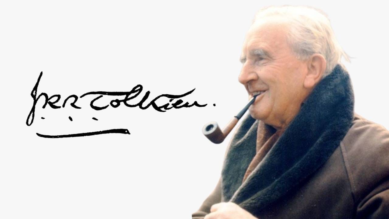A color photograph of an older J.R.R. Tolkien smiling with a pipe in his mouth on the right side of the image, placed next to his stylized, sweeping black signature against a white background on the left.