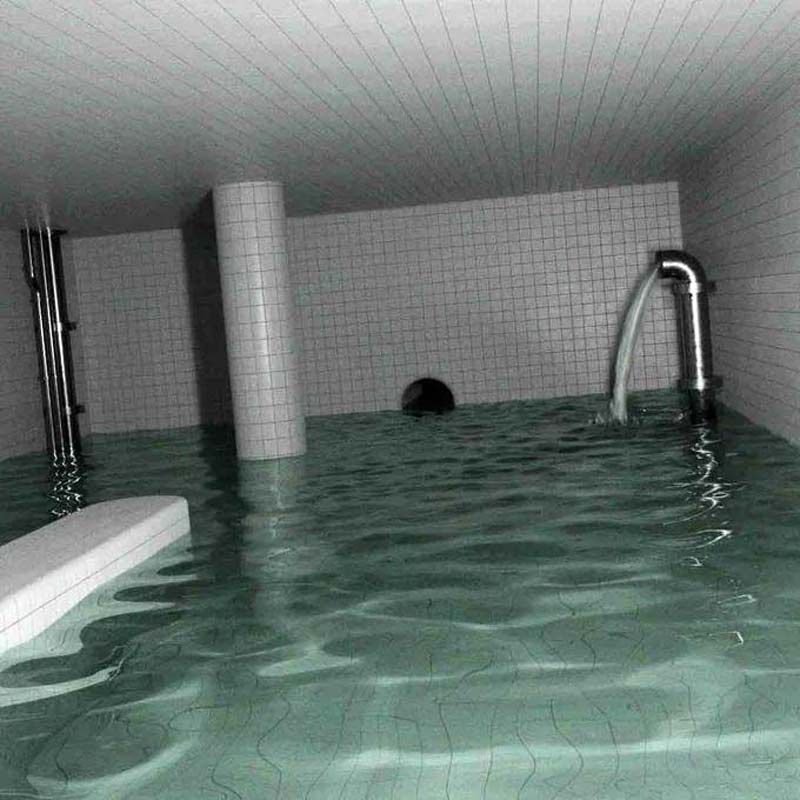 A flash photograph of an eerie, indoor pool room completely submerged in murky green water. The walls, ceiling, and structural pillars are entirely lined with white square tiles. A large metallic pipe on the right wall continuously discharges a stream of water into the pool, while a small, dark circular tunnel opening is visible on the far wall near the water's surface.