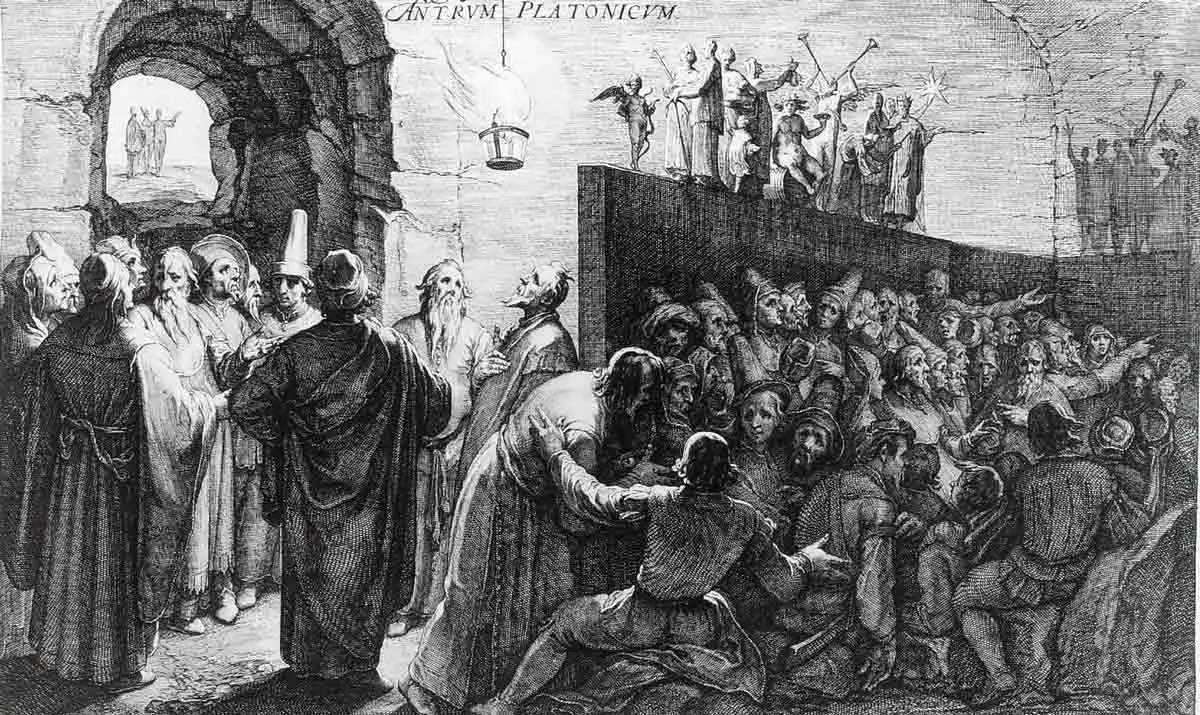 A detailed, classical black-and-white engraving illustrating Plato's Cave, showing chained prisoners gazing at shadows on a cave wall while figures behind a partition hold up statues in front of a blazing fir