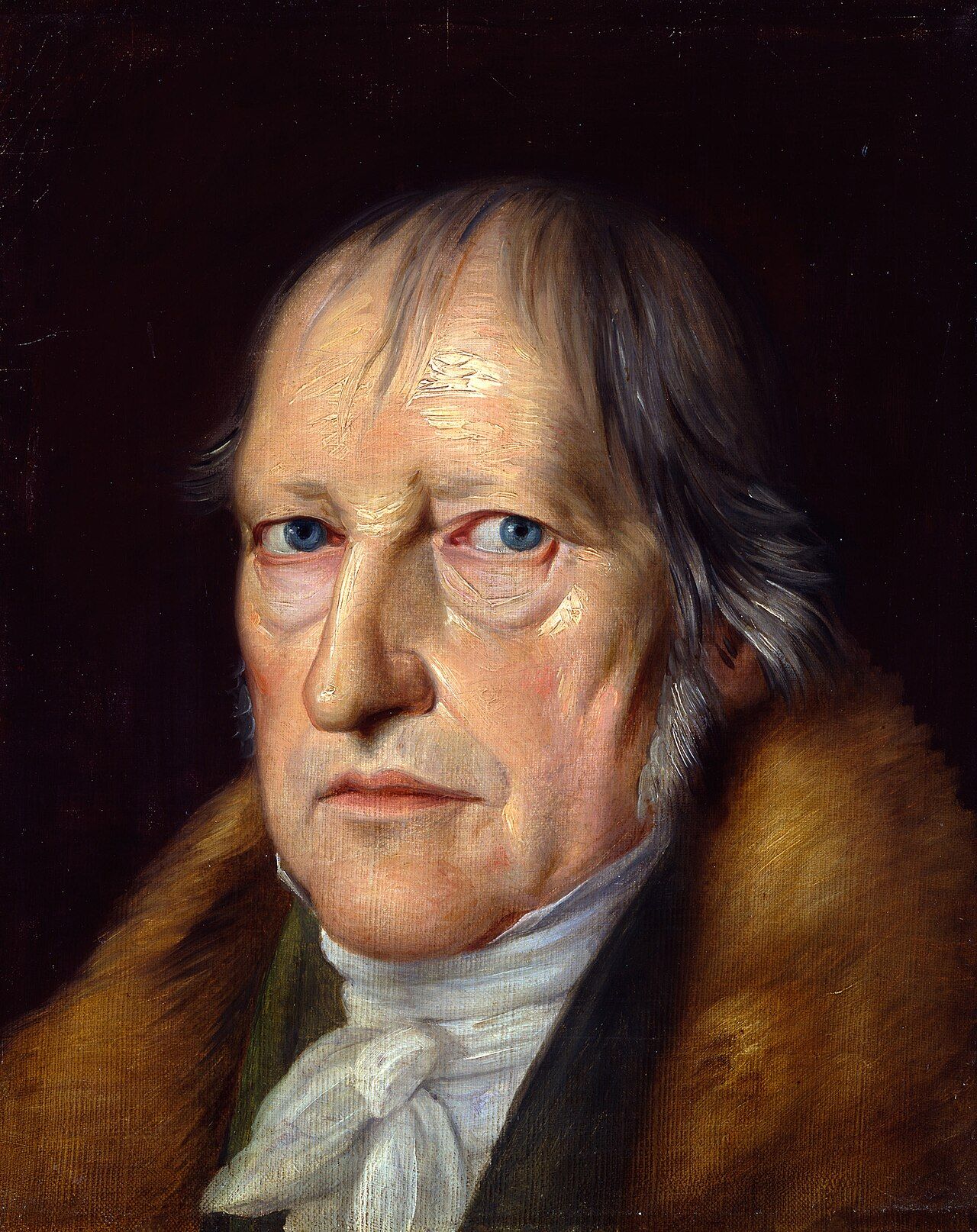 A formal, close-up portrait of the German philosopher Georg Wilhelm Friedrich Hegel, set against a dark, somber background. He has an elderly, intellectual appearance, with thinning, grayish hair and striking, intense blue eyes directed toward the viewer. He is dressed in a period-appropriate white cravat and high-collared coat, over which he wears a luxurious, thick, brown fur-lined garment. The lighting highlights the textures of his skin and the soft, textured fur, conveying a sense of serious contemplation and gravitas.