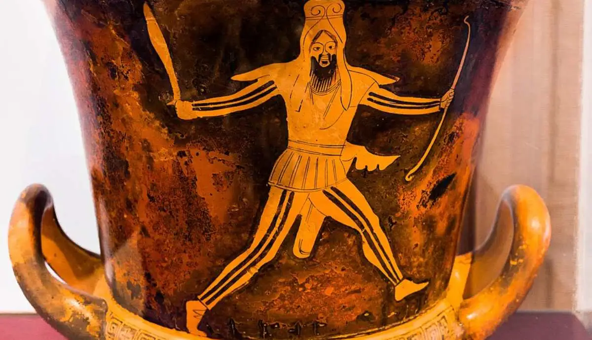 an ancient Greek vase painting of a Persian soldier in traditional patterned clothing and headwear on the right.