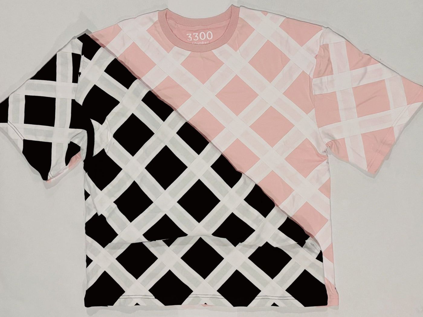 Pink and black lattice tees laid together on white