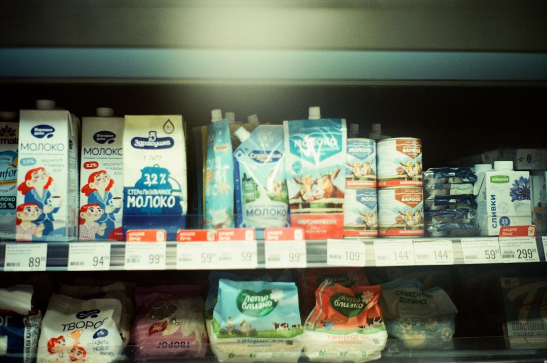 A selection of different organic milk cartons displayed on a supermarket shelf.