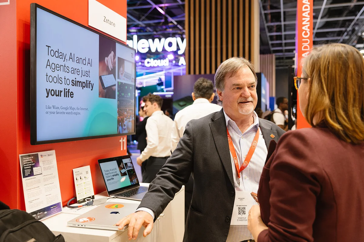 Zetane’s CEO and Co‑Founder speaking with a visitor at the Canada booth during VivaTech 2026, explaining the company’s applied and sovereign AI platform.