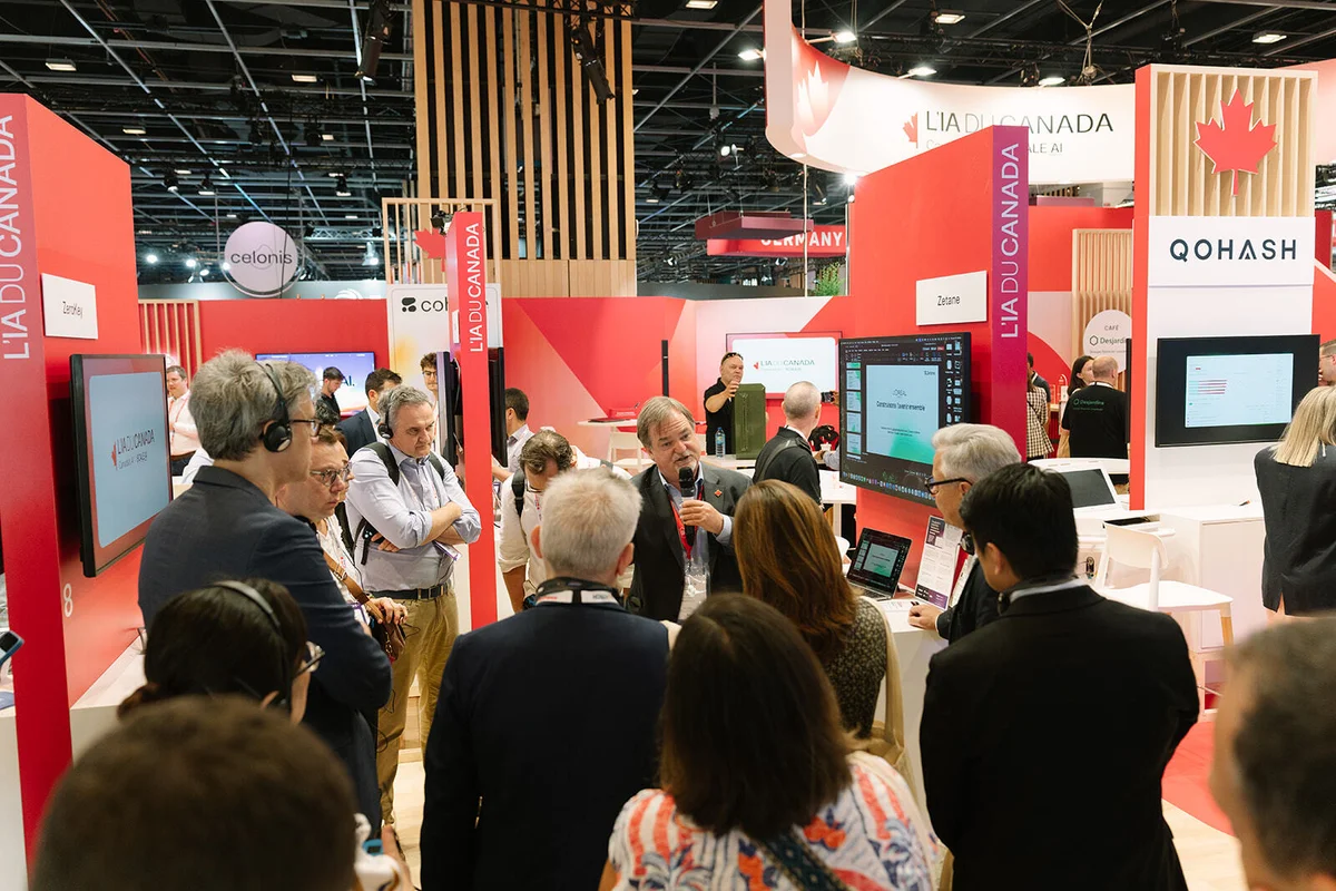 Zetane’s CEO and Co‑Founder presenting the company’s applied AI platform to a group of visitors at the Canada booth during VivaTech 2026.