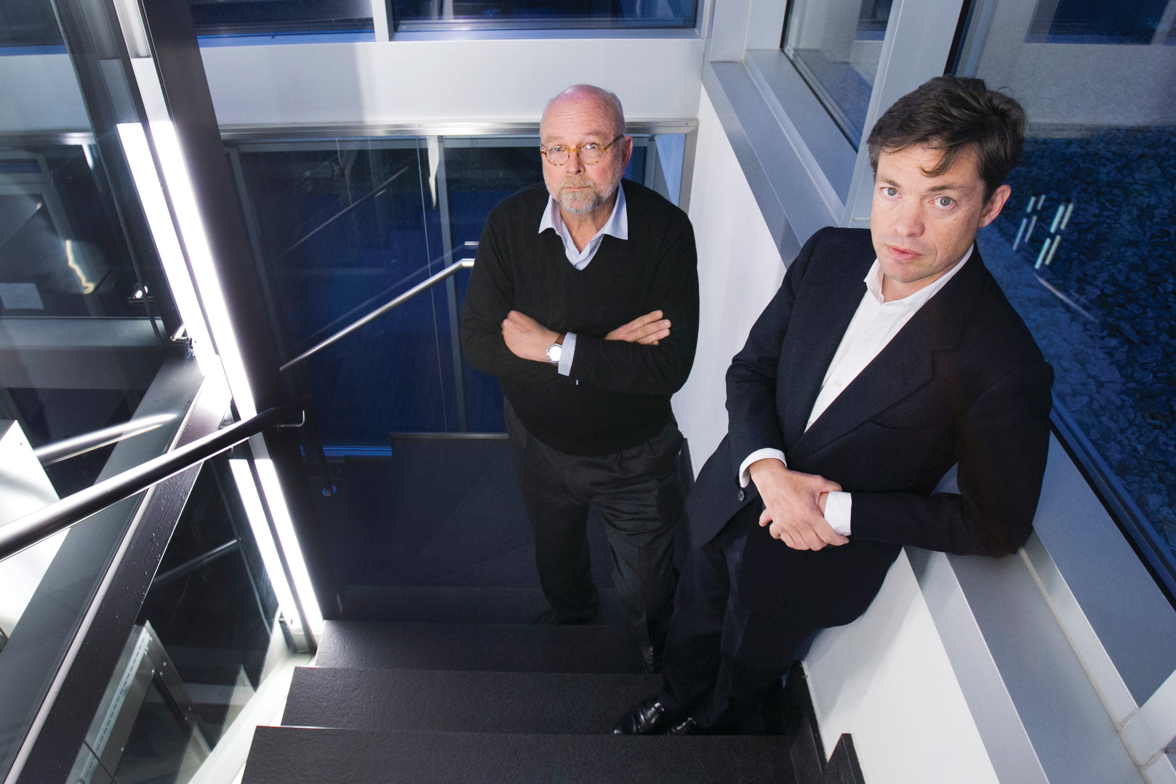 Nathan Gardels and Nicolas Berggruen standing in a stairwell