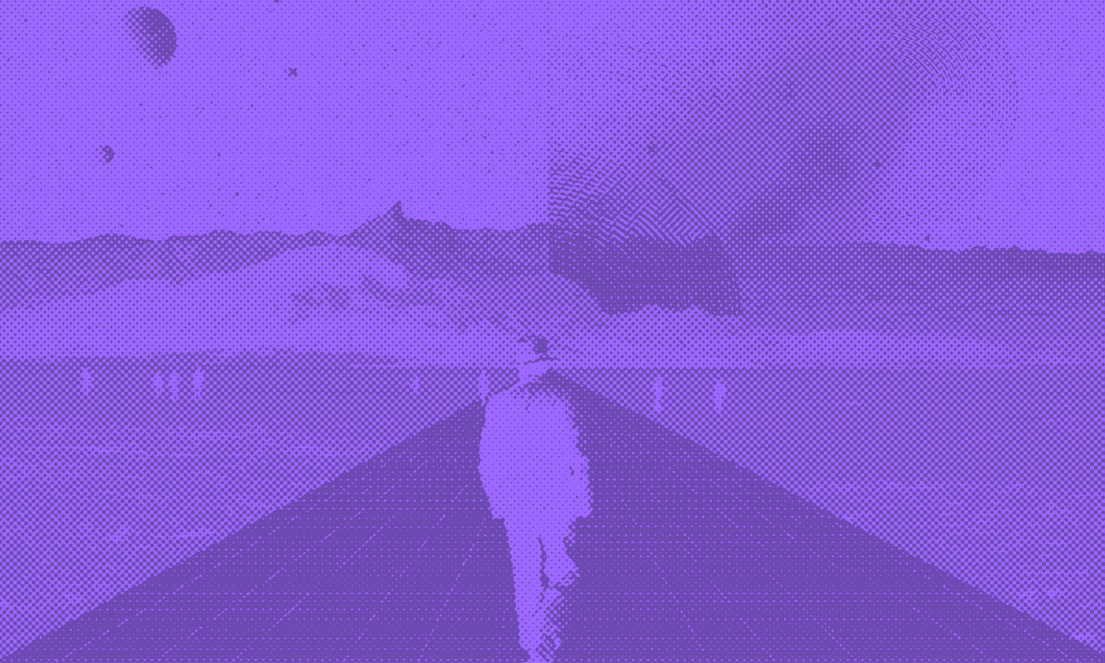 A man in a hat walking down a road