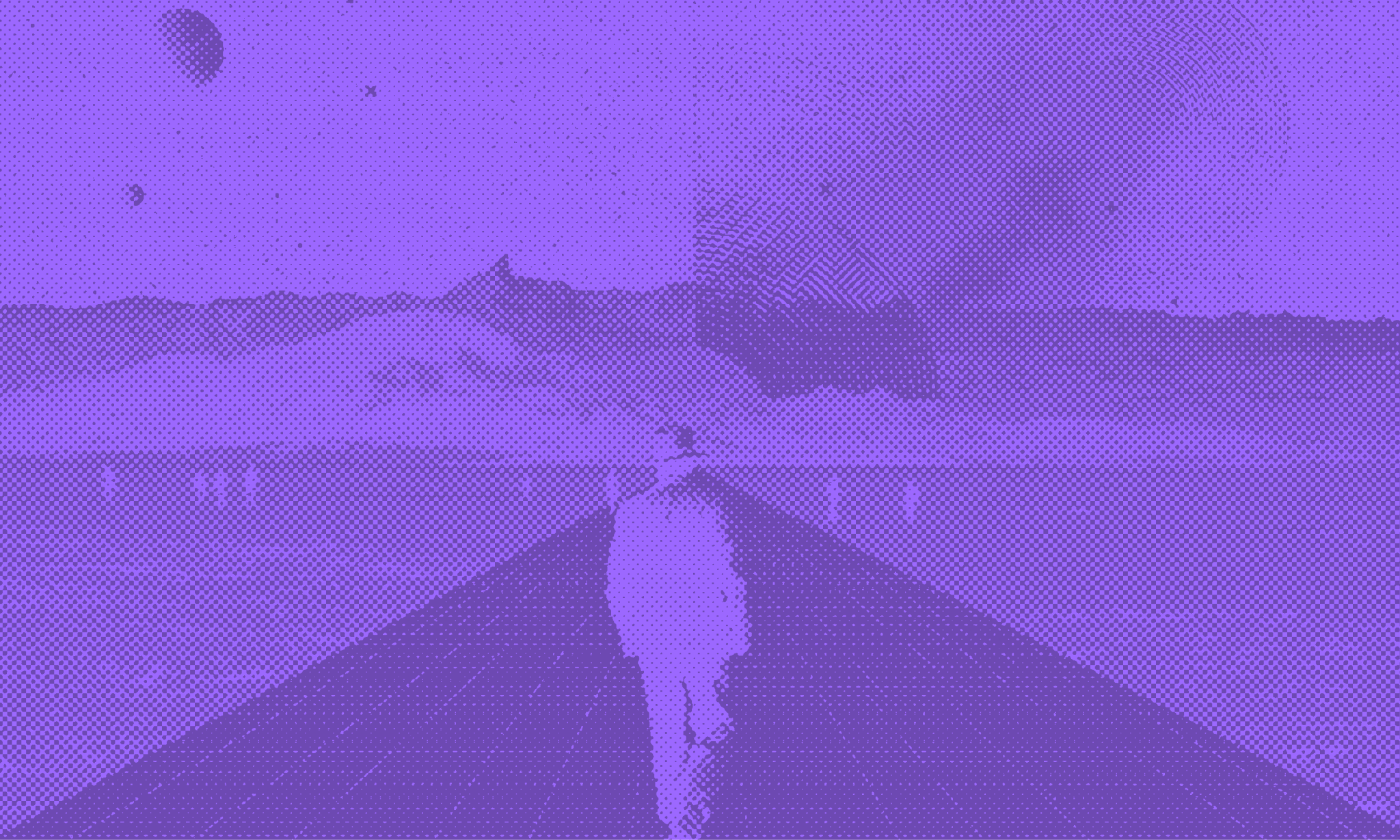 A man in a hat walking down a road
