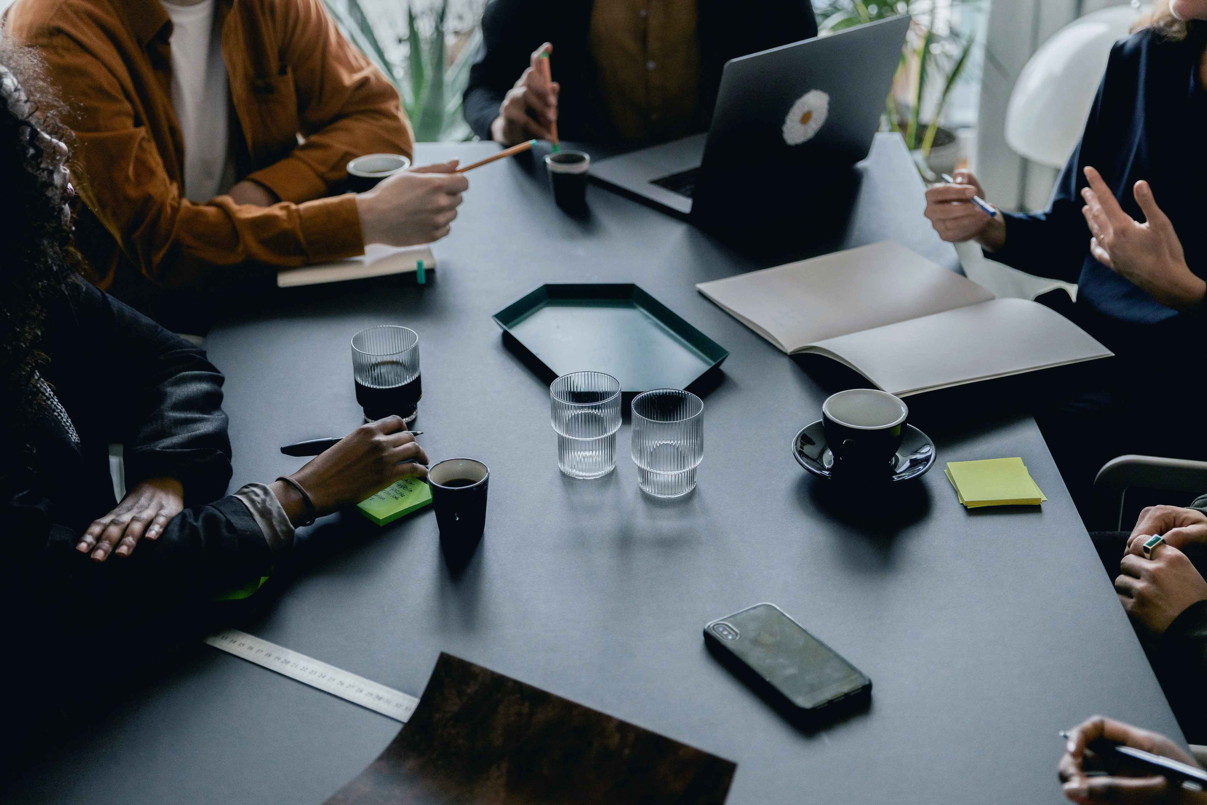 Business meeting around a table in a cafe environment with people interacting