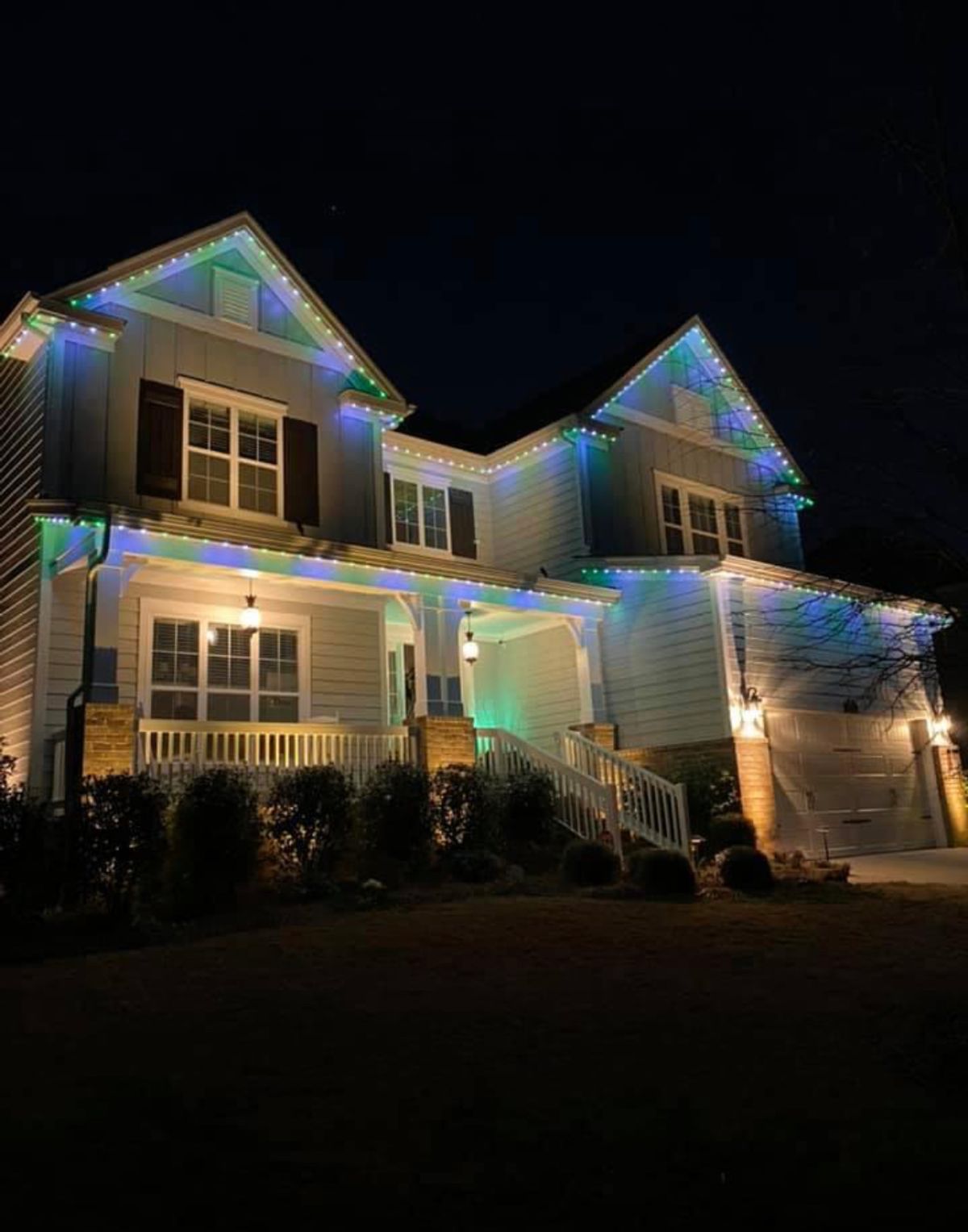 Charlotte craftsman home with warm-white Trimlight at dusk