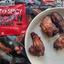 Crispy, cooked Discover-In Hot & Spicy Chicken Wings on a plate, with the black and red 750g packaging visible behind.