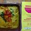 An overhead review photo of the M&S Taste of Asia Chicken Panang Curry. The prepared Thai curry is shown in its dish next to the yellow and pink product sleeve.
