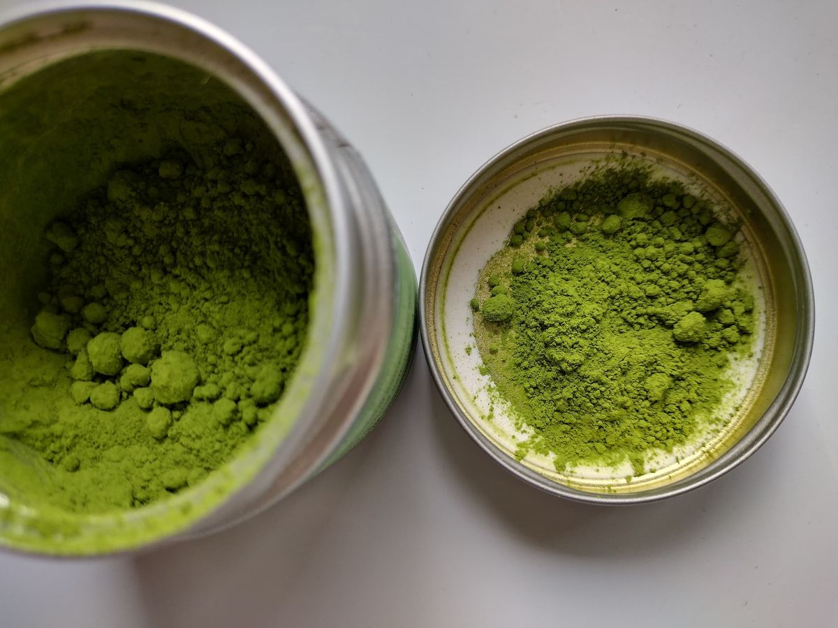 Close-up of vibrant green Midori Matcha Premium Uji ceremonial grade powder showing its fine texture in the tin.
