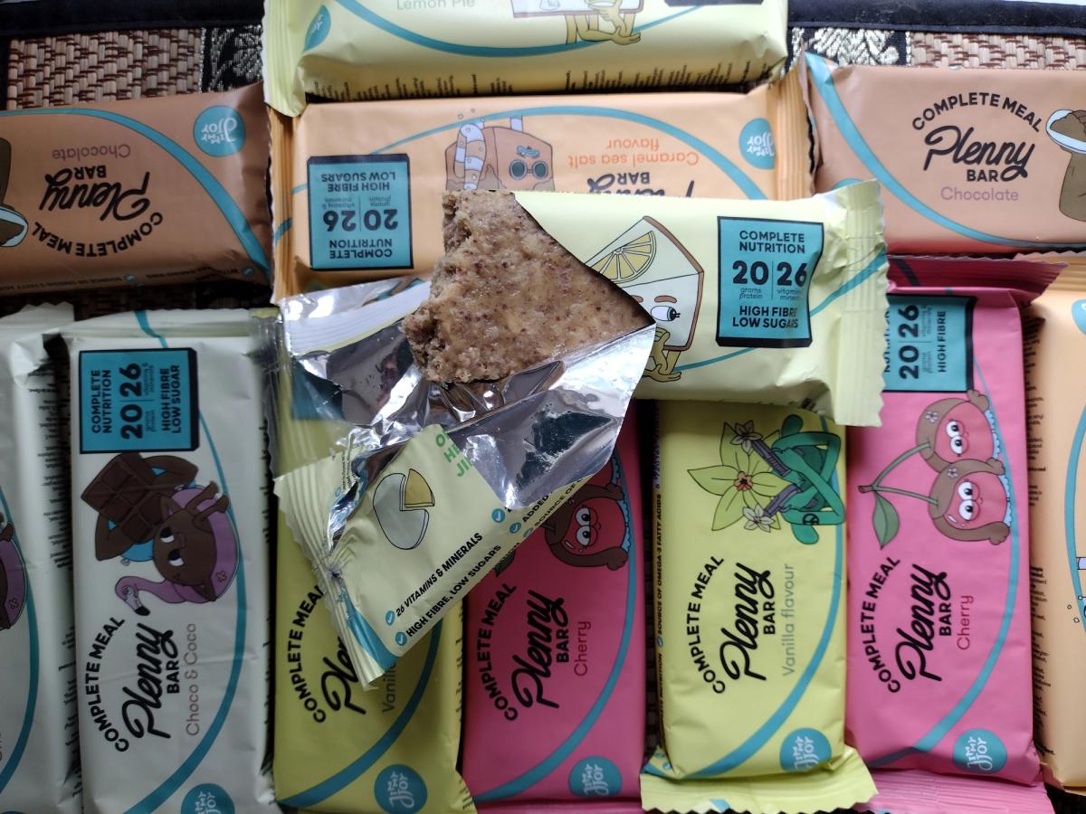 An assortment of Jimmy Joy's Plenny Bars, highlighting the variety pack and the dense inner texture of the Lemon Pie flavour for a product review.