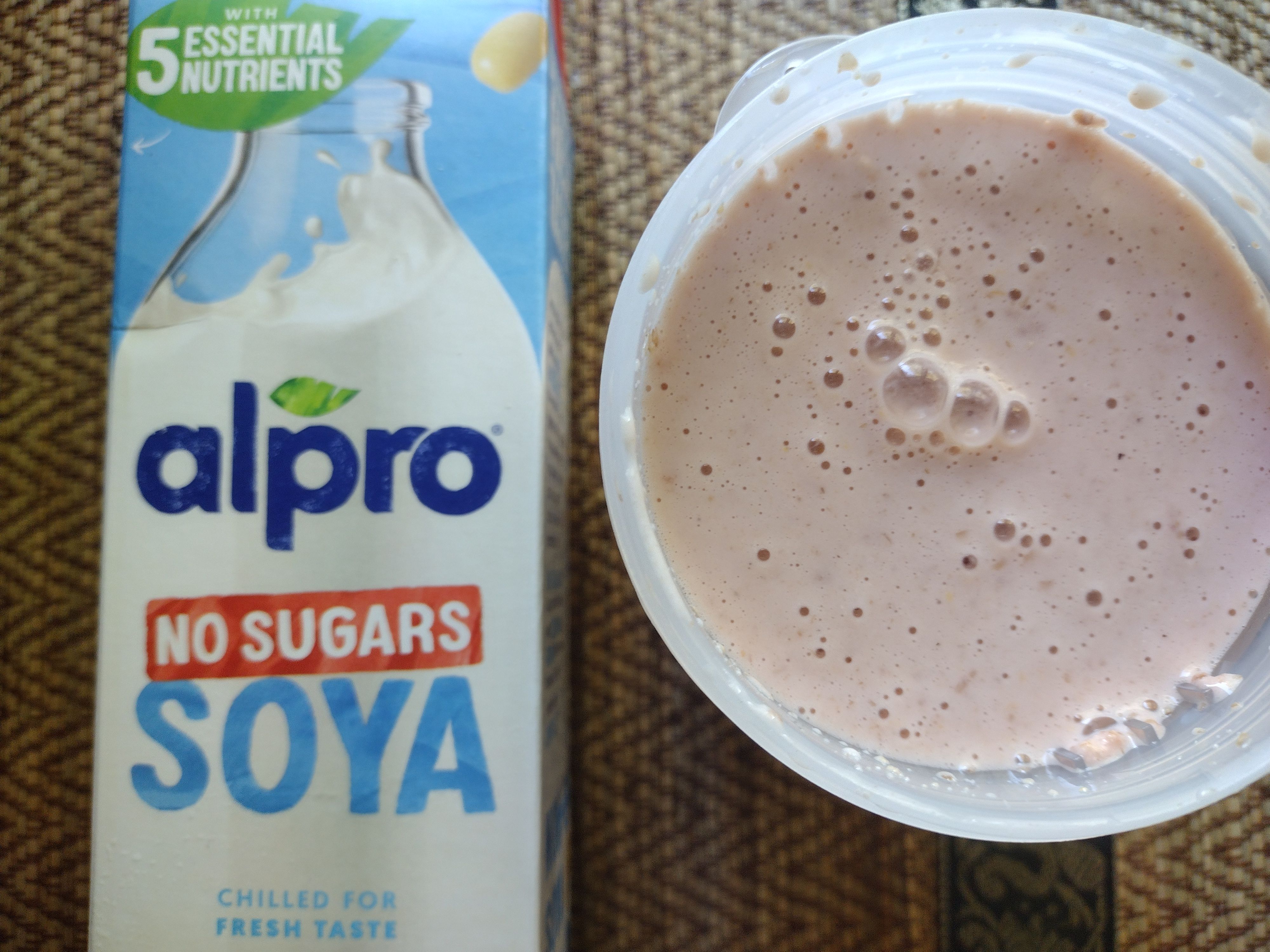 The Protein Works Complete 360 Meal shake mixed with Alpro No Sugars Soya milk, shown in a shaker cup next to the Alpro carton.