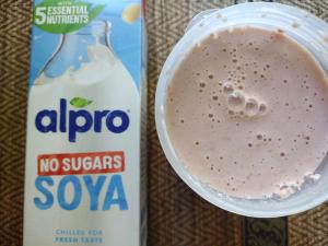 The Protein Works Complete 360 Meal shake mixed with Alpro No Sugars Soya milk, shown in a shaker cup next to the Alpro carton.