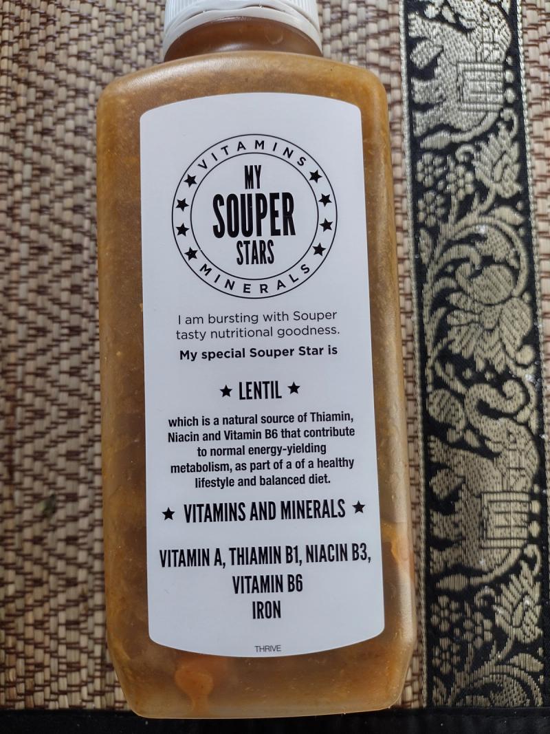 Close-up of the Renourish Chicken & Vegetable soup bottle, focusing on the 'My Souper Stars' label which highlights Lentil as the key ingredient and lists its nutritional benefits including vitamins and iron.
