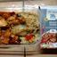 The prepared M&S Buffalo Chicken ready meal showing chunks of chicken in a spicy sauce with sweet potato, beans, and brown rice, alongside its M&S packaging.