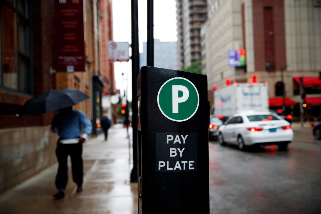 A "pay by plate" parking meter on the street.