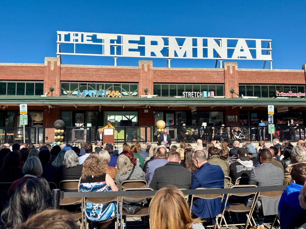 A crowd seated outdoors for a Pittsburgh Walk of Fame ceremony in front of The Terminal in the Strip District, with a speaker at a podium and the large “The Terminal” sign above a brick building.
