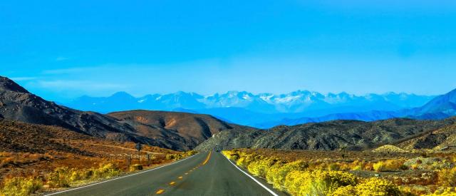 A highway with Nevada mountains in the background.