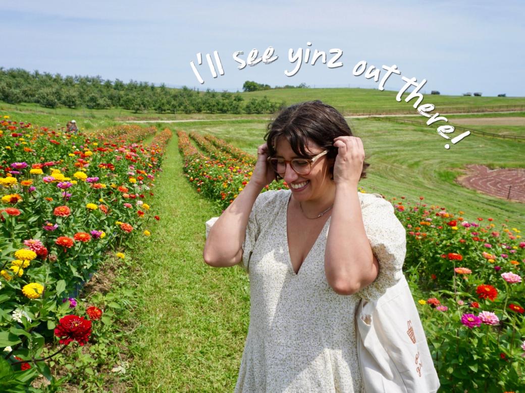Our lovely queen Francesca Dabecco stands in a green field full of flowers.