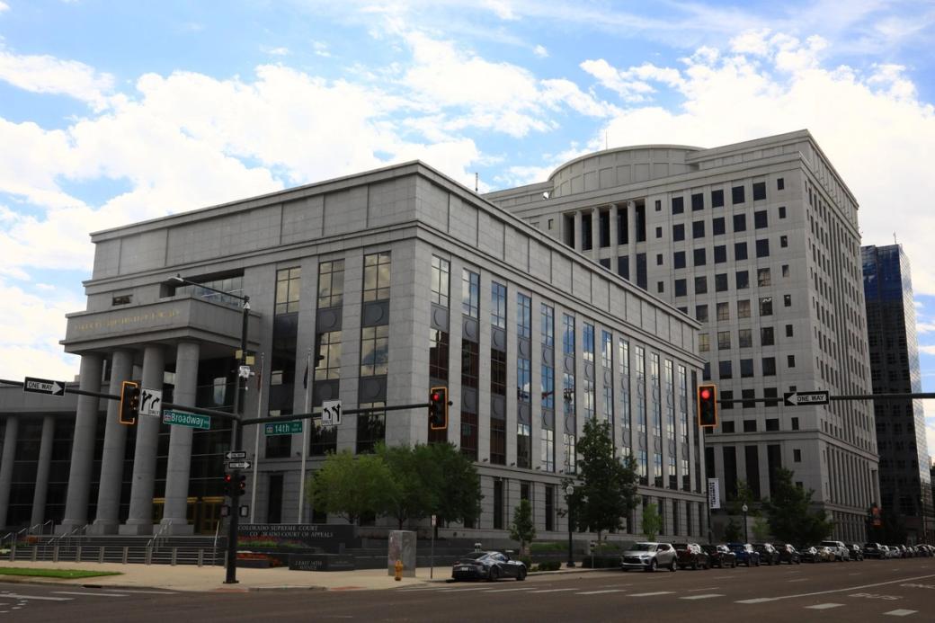 A concrete building with the words "liberty and justice for all" etched in 