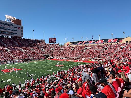 A packed crowd wearing red fills the stands at Rice-Eccles Stadium.