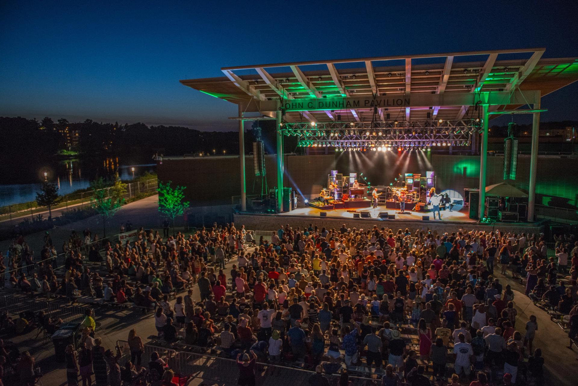 Performers onstage at night at RiverEdge Park in Aurora