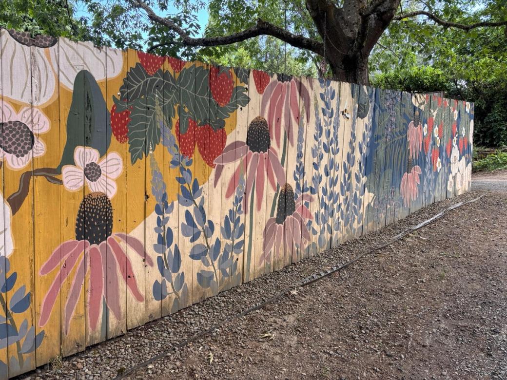 A mural of flowers: echinacea, dogwoods, as well as some leaves and strawberries.