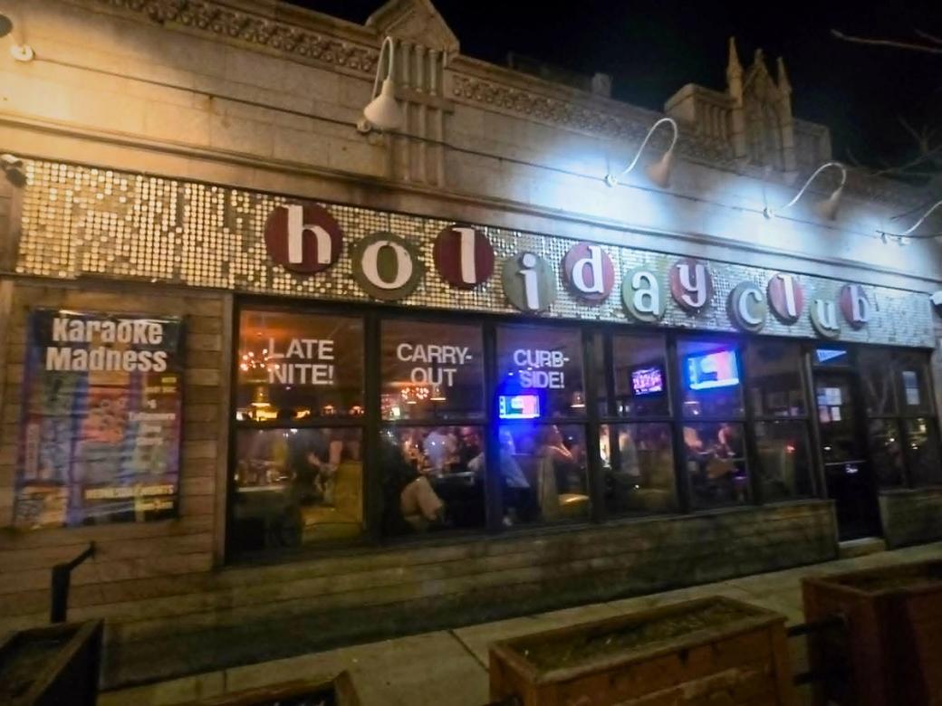 A street shot of a building. The sign says "holiday club"