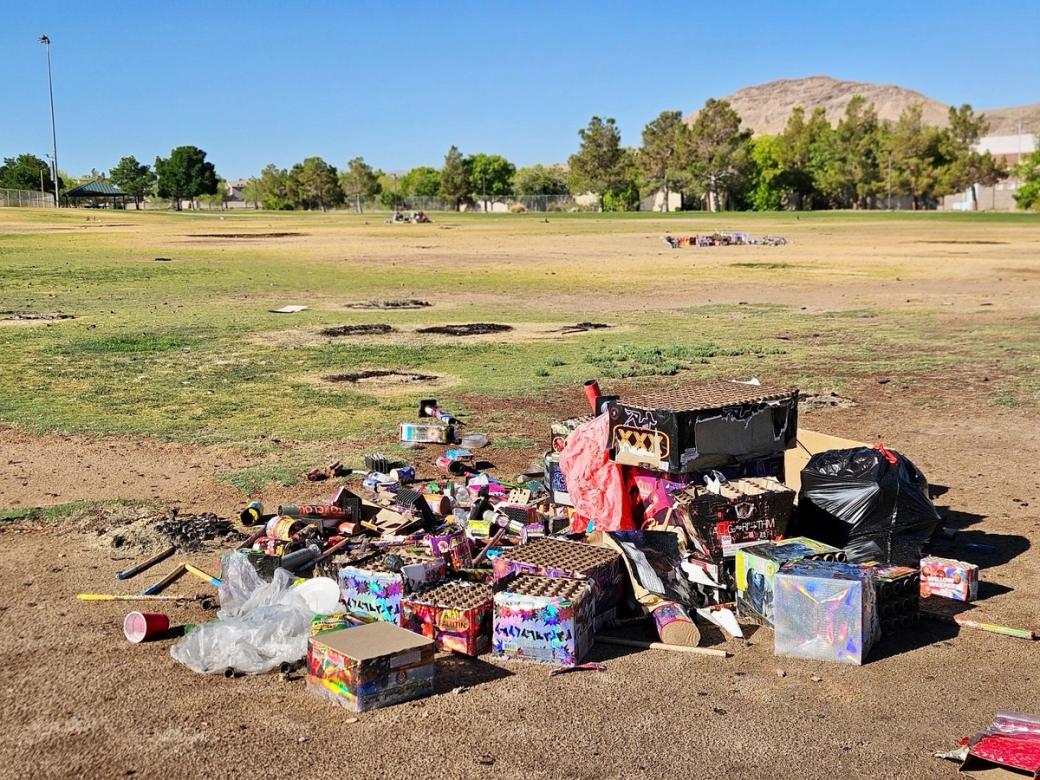A garbage pile sits on the dirt of Red Ridge Park.