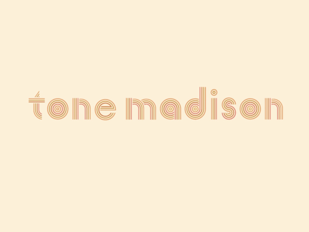 The orange words "TONE MADISON" on a beige backdrop.
