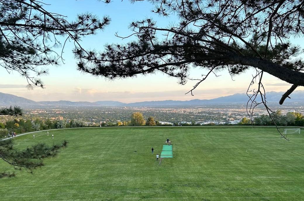 Cricket pitch at a park with a view of the Salt Lake Valley.