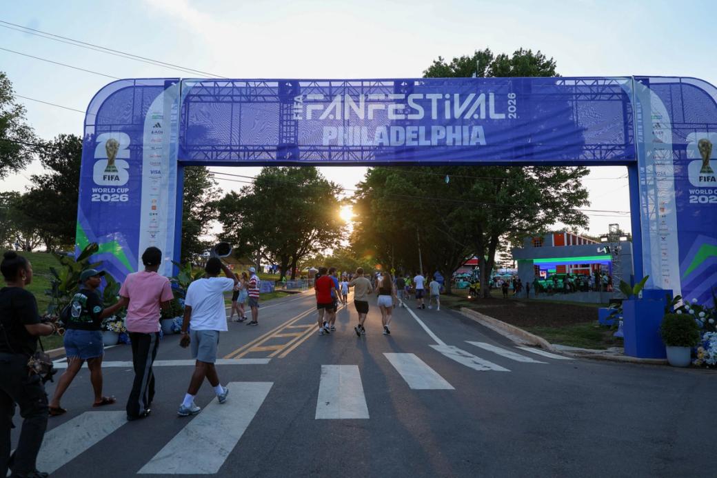 Pedestrians walk under the FIFA Fan Festival entry arch at Lemon Hill