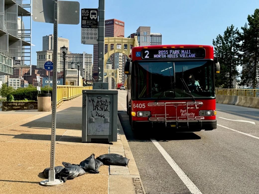 A red PRT bus in Downtown Pittsburgh bound for Ross Park Mall.