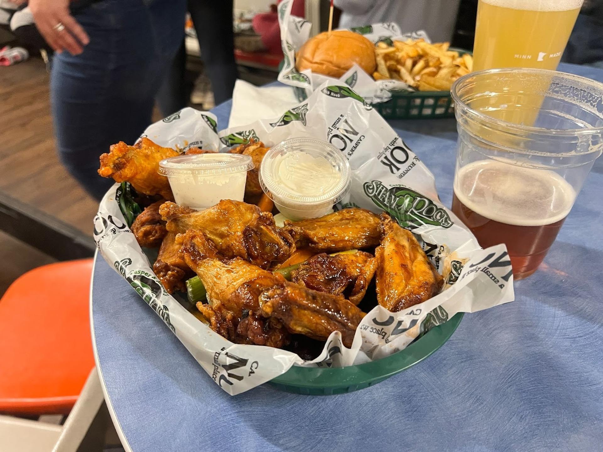 Yellowish orange chicken wings in a basket