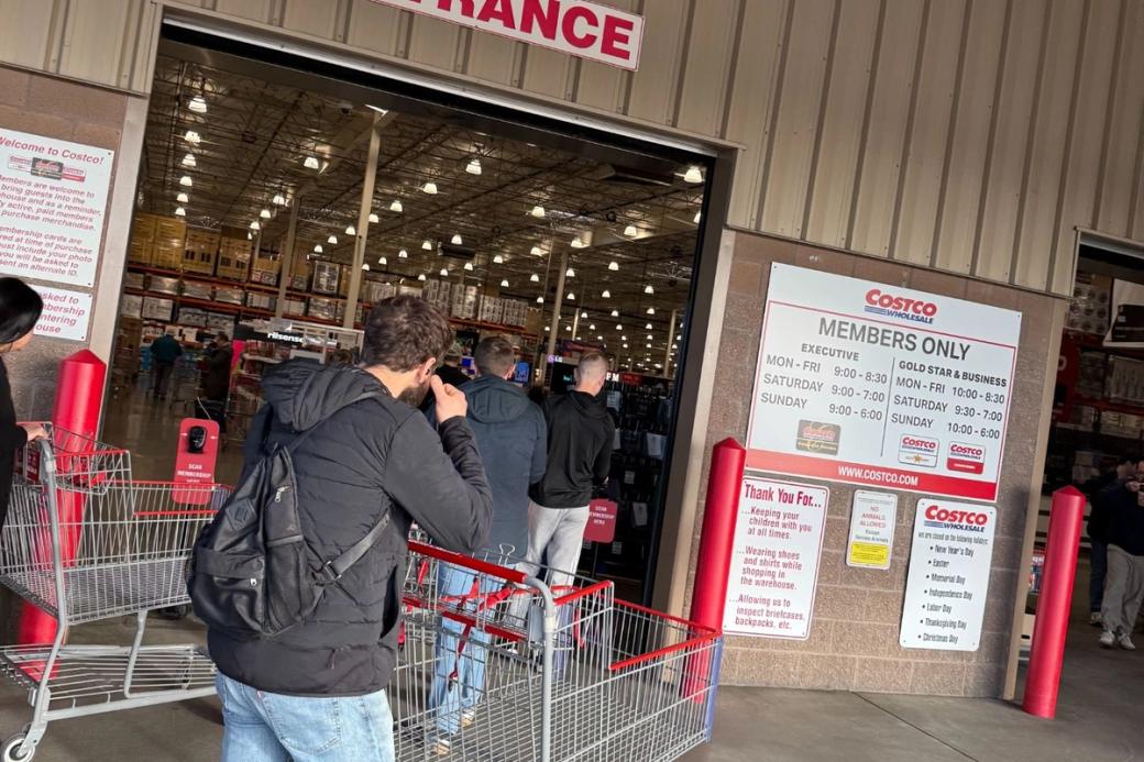 An image of customers with empty carts enter the Seattle Costco