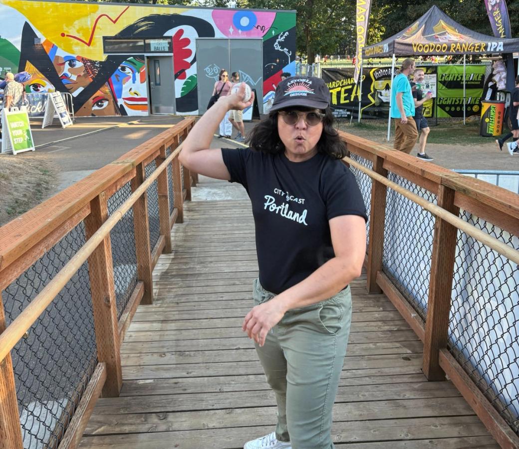 Podcast host Claudia Meza holding a baseball