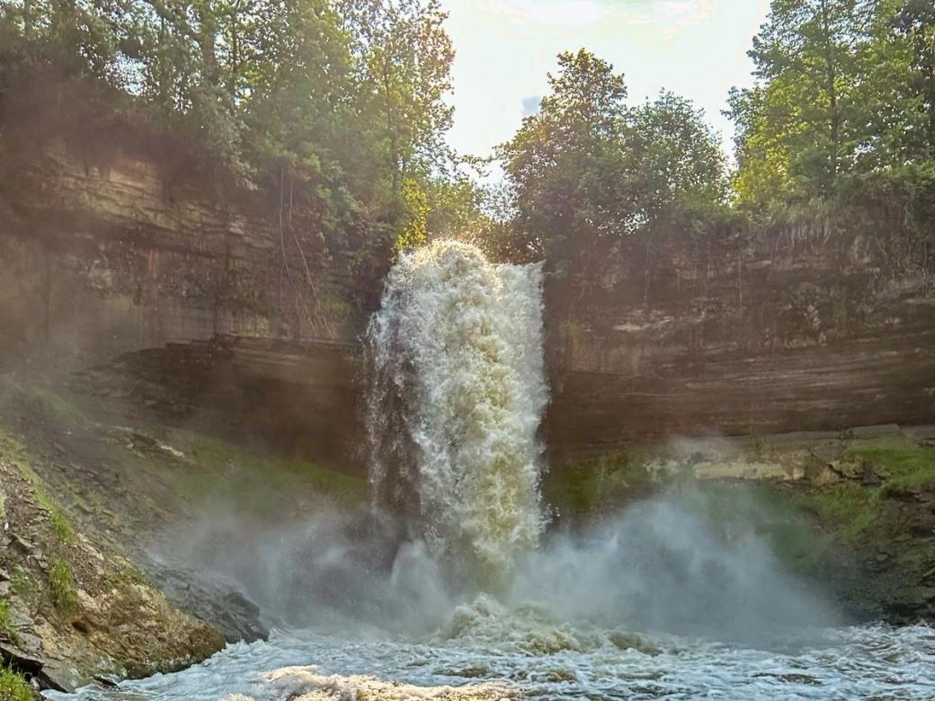 Large waterfall with trees at the top